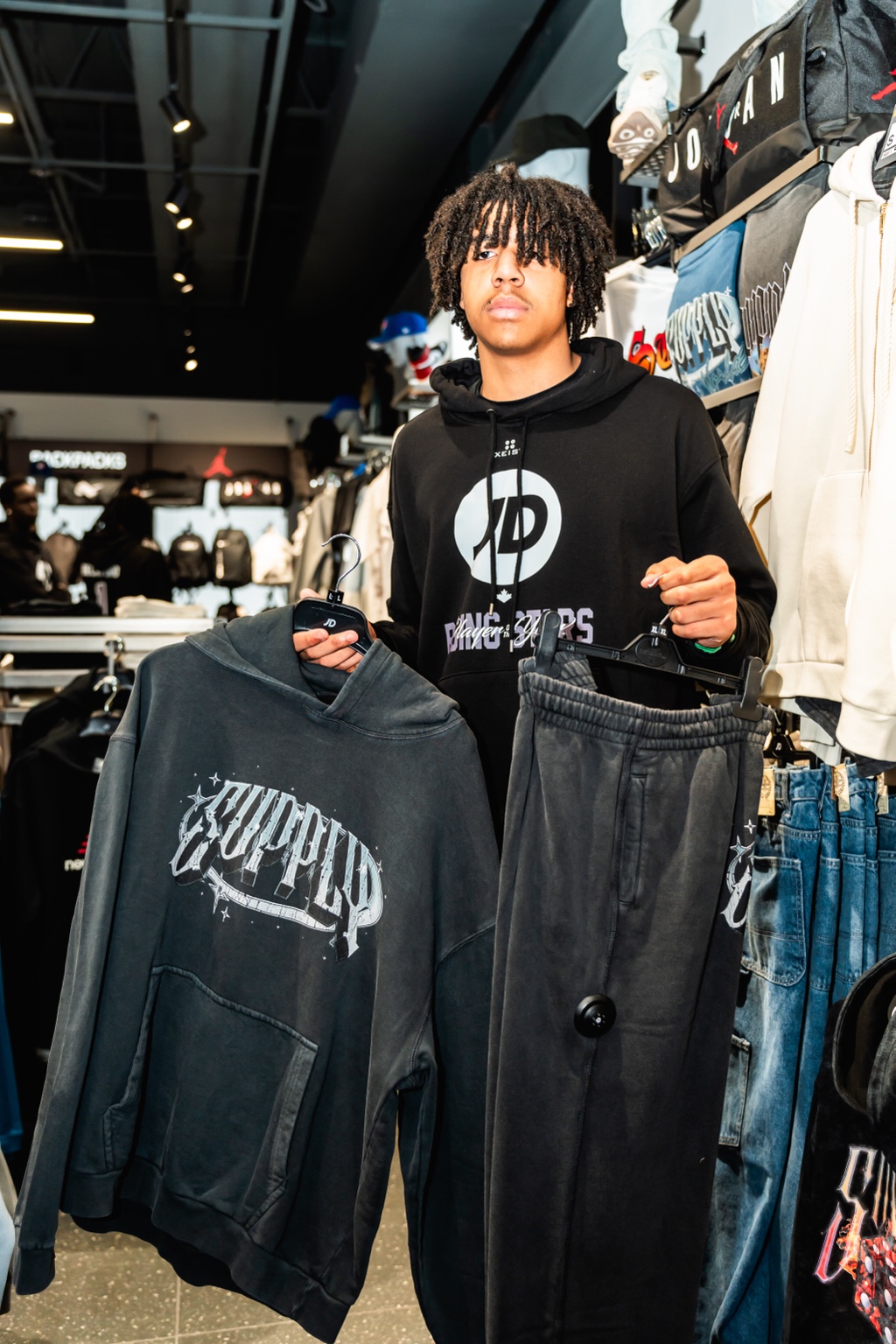 Young athlete presenting apparel during a JD Sports Canada retail activation